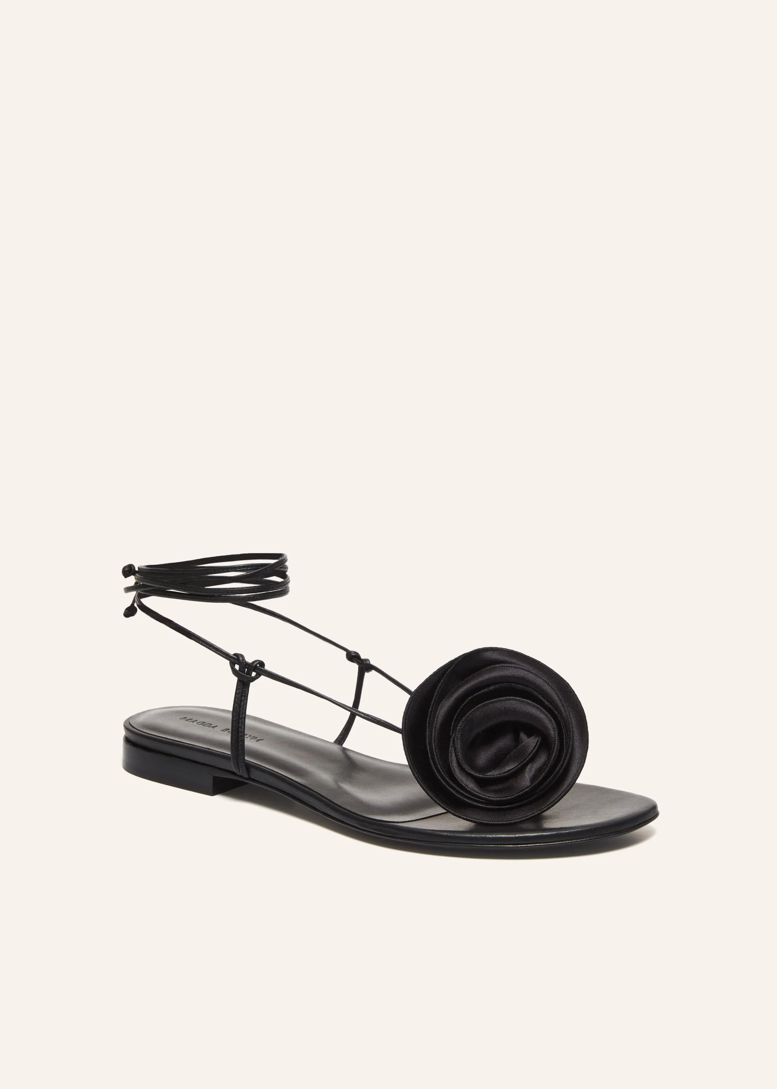 Wrap around flat flower sandals in black satin